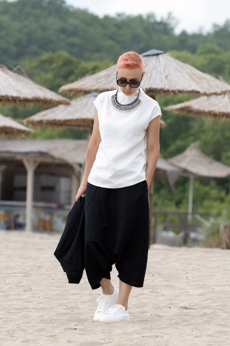 Model wearing structured black summer top with clean lines