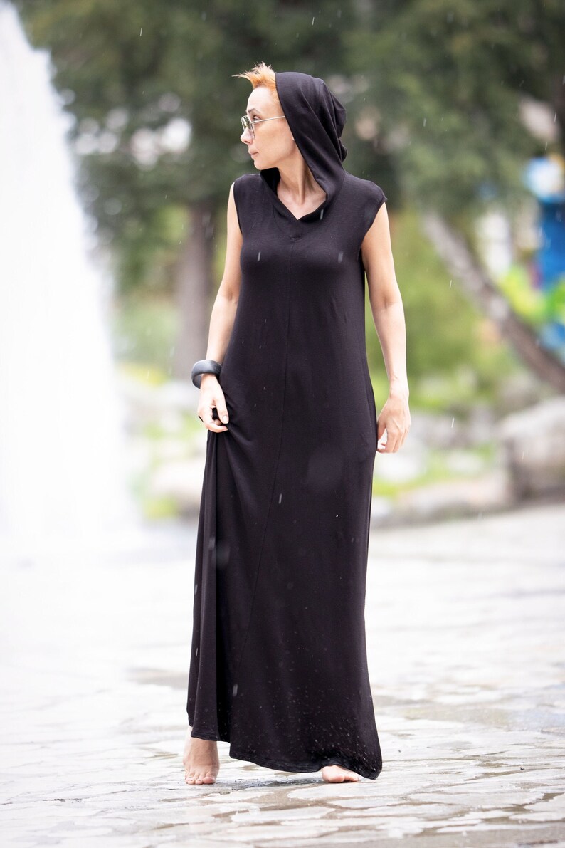Model wearing long casual hoodie dress with pockets