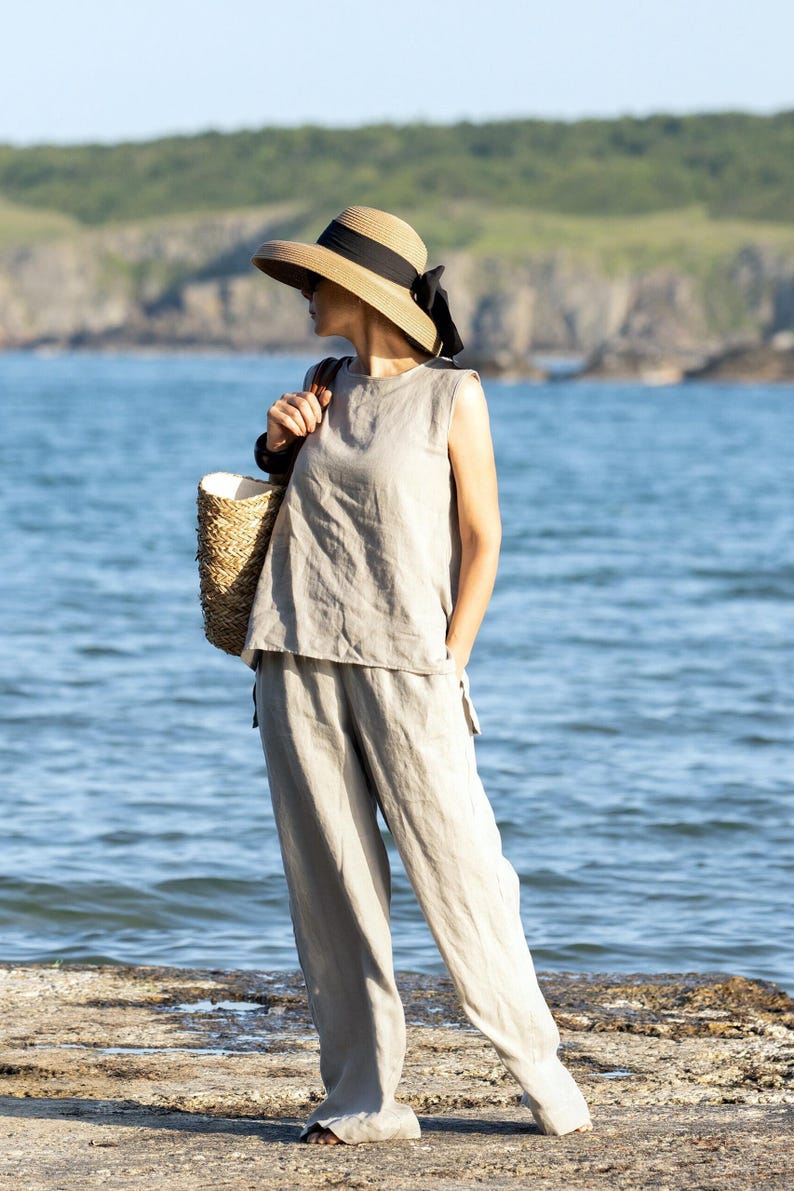 Model in sleeveless summer linen outfit in pastel tone