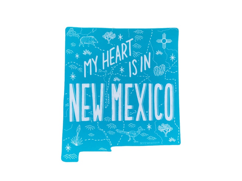 May include: A blue sticker with a white outline of the state of New Mexico. The sticker has a white graphic design with the text "My heart is in New Mexico".