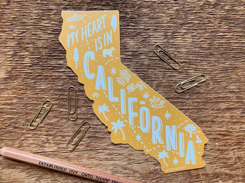 May include: A yellow outline of the state of California with the text "My heart is in California" and various illustrations of palm trees, mountains, and stars.