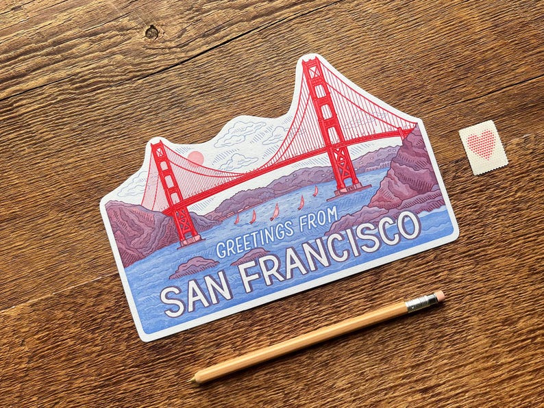 May include: A red and white illustration of the Golden Gate Bridge with the text "Greetings from San Francisco".