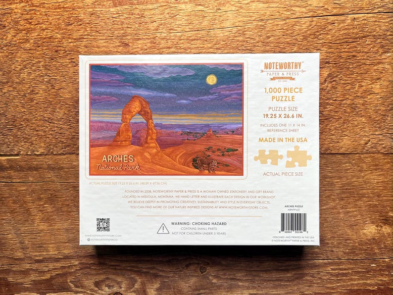 May include: A 1,000 piece jigsaw puzzle featuring a scenic view of Delicate Arch in Arches National Park, Utah. The puzzle is made in the USA and measures 19.25 x 26.6 inches.