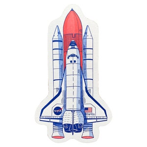 May include: A white and blue space shuttle with a red rocket booster. The shuttle is labeled "NASA" and "Atlantis".