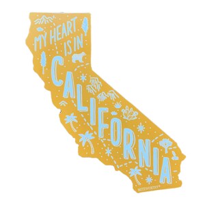 May include: A yellow outline of the state of California with the text "My heart is in California" in blue lettering. The outline includes various illustrations of California landmarks and nature, such as palm trees, mountains, and cacti.