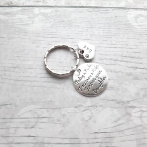 May include: Silver keychain with a round charm that reads "Today a Bride, Tomorrow a Wife, Forever your Daughter". A small heart charm with the word "Dad" is attached to the keychain.