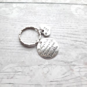 May include: Silver keychain with a round charm that reads "Today a Bride, Tomorrow a Wife, Forever your Daughter" and a small heart charm that reads "Dad".