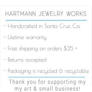 May include: White background with the text "HARTMANN JEWELRY WORKS". Additional text includes "Handcrafted in Santa Cruz, Ca.", "Lifetime warranty", "Returns accepted", and "Packaging is recycled & recyclable". The text "Thank you for supporting my art & small business!" is also present.