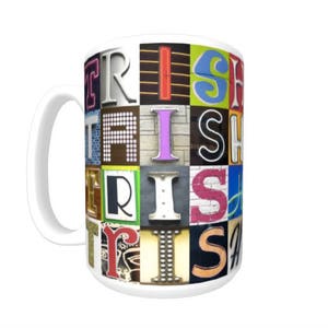 May include: White ceramic mug with a colorful design featuring the word "Irish" spelled out in different fonts and colors. The letters are arranged in a grid pattern.