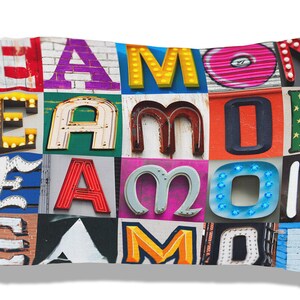 May include: A white pillow with the name "Eamon" spelled out in colorful, vintage-style letters. Each letter is a different color and has a unique design.