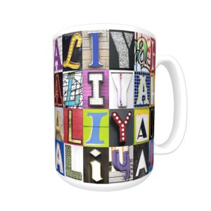 May include: White ceramic mug with a colorful design featuring the letters "ALLY" in a mosaic of different fonts and colors.