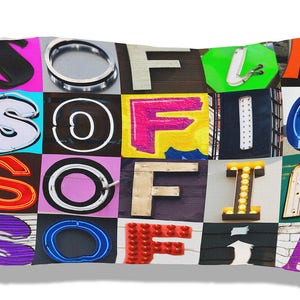 May include: A white pillowcase with a colourful patchwork design featuring the letters "SOFIA" in various fonts and styles. Each letter is made up of different textures and materials, creating a unique and eye-catching design.