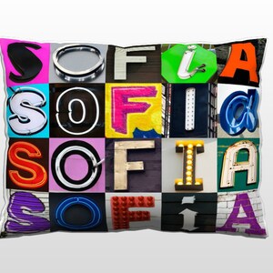 May include: A colorful pillow with the name "SOFIA" spelled out in different fonts and colors. Each letter is made of a different material, such as neon signs, metal, and plastic.