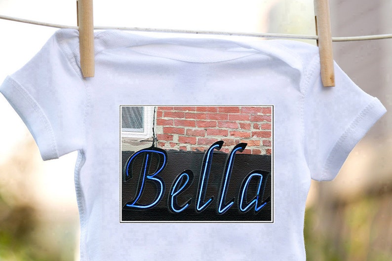 Personalized baby bodysuit featuring the name BELLA showcased in a photo of an actual sign; Baby gift; Baby shower