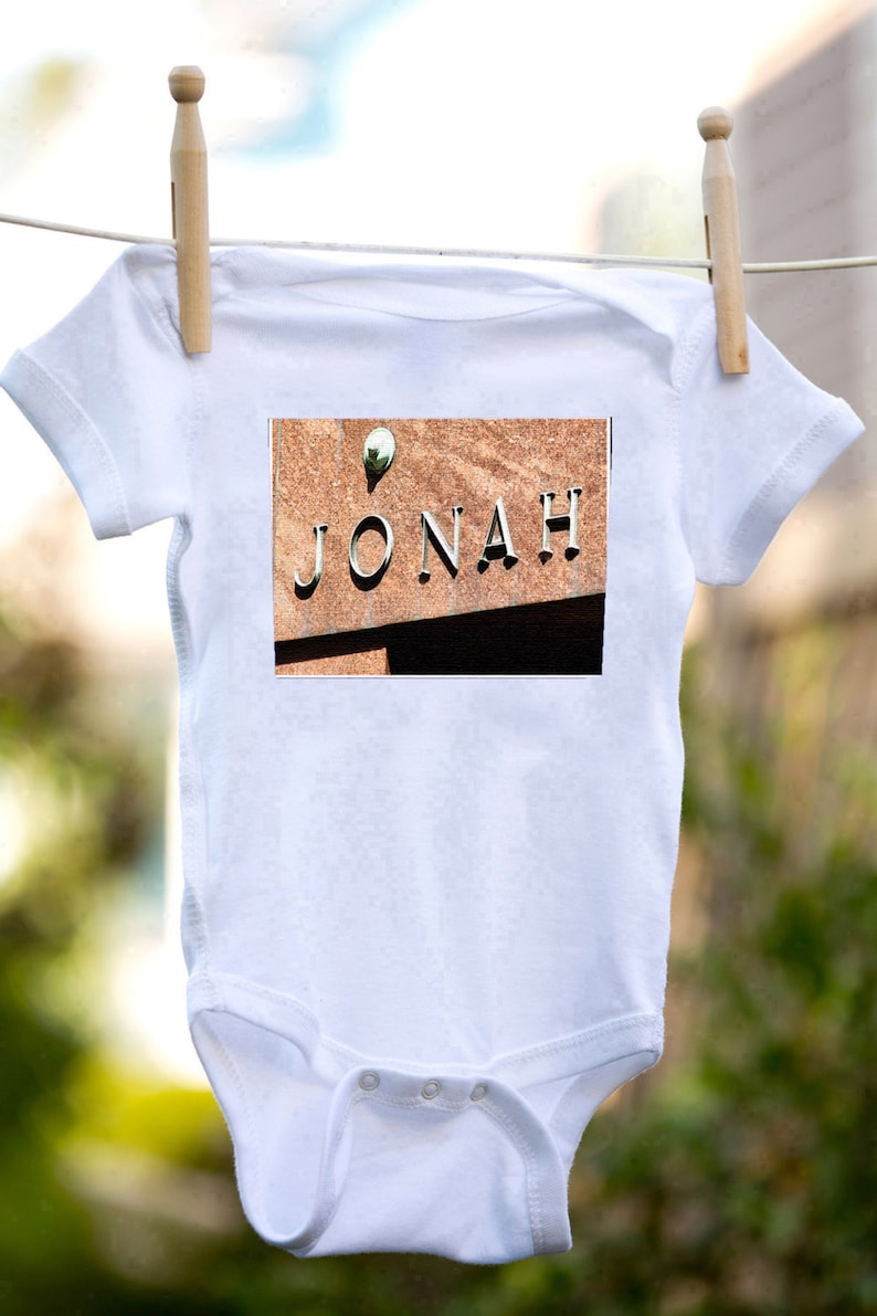 Personalized baby bodysuit featuring the name JONAH showcased in a photo of an actual sign; Baby gift; Baby shower