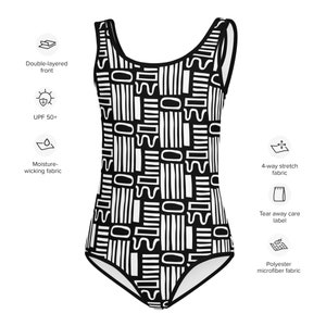 May include: Black and white geometric print one-piece swimsuit with a scoop neck and thin straps. The swimsuit is made of polyester microfiber fabric and has a tear-away care label.