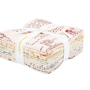 May include: A stack of fabric squares tied with a white ribbon. The fabric has a cream background with colorful text and illustrations. The ribbon is printed with the words "create colorfully".