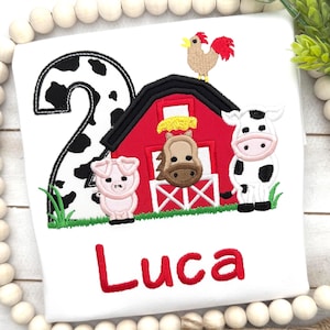 May include: A white ceramic mug with a black handle and the text "But First, Coffee" in a black, bold font. The mug is on a white surface.