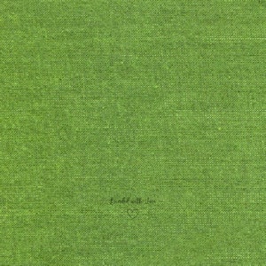 May include: Close-up of a textured, bright green fabric. The fabric has a woven appearance, with a slightly uneven surface. The words "Bundled with Love" are written in a cursive font at the bottom right corner, with a small heart symbol.