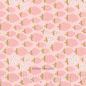 May include: Pink fabric with a repeating pattern of strawberries in varying sizes. The strawberries are light pink with white seeds and gold-colored stems. Some strawberries are white with pink seeds. The words "BOUNDED WITH LOVE" are printed on the fabric.