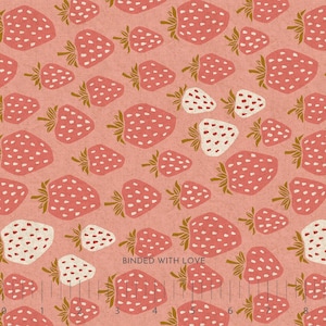 May include: A fabric with a repeating pattern of pink strawberries with green stems and white seeds on a light pink background. The text "BOUNDED WITH LOVE" is visible.