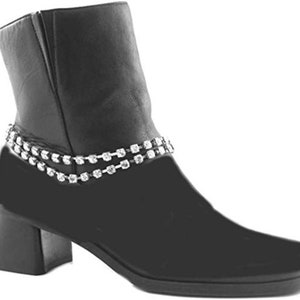 May include: Black ankle boot with a square toe and a small block heel. The boot features a double strand of sparkling rhinestones around the ankle. The boot has a zipper closure on the side.