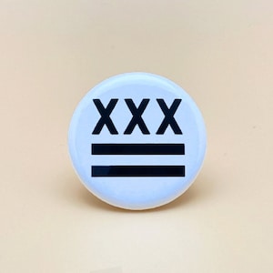 May include: White button with black text that reads "XXX" and two black horizontal lines.