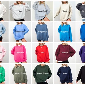 May include: A selection of crew neck sweatshirts in a range of colours. The colours include white, ash, sport grey, sand, dark heather, light blue, carolina blue, indigo blue, sapphire, royal, light pink, heliconia, red, maroon, purple, irish green, military green, forest green, navy, and black.