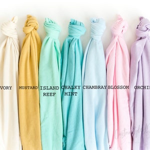 May include: Seven fabric swatches in different colors, from left to right: ivory, mustard, island reef, chalky mint, Chambray, blossom, and orchid.