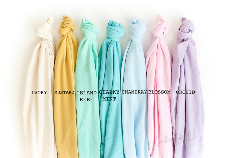 May include: Seven fabric swatches in different colors, from left to right: ivory, mustard, island reef, chalky mint, Chambray, blossom, and orchid.