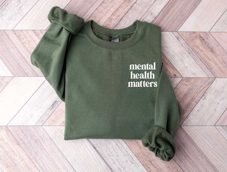 May include: A dark green sweatshirt with the text "mental health matters" printed in white on the front.