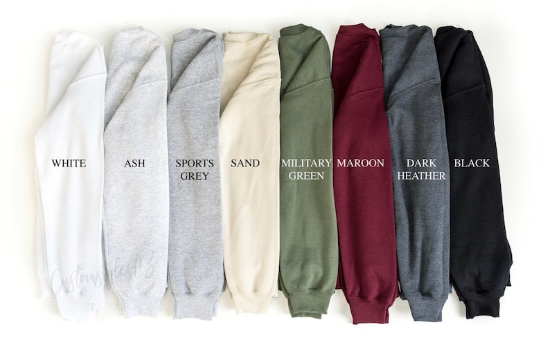 May include: A row of ten sweatshirts in different colours, including white, ash, sports grey, sand, military green, maroon, dark heather, and black.