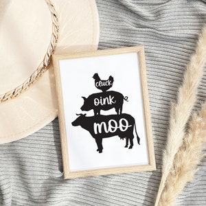 May include: A framed print with a black and white illustration of a chicken, pig, and cow stacked on top of each other. The text "cluck oink moo" is written below the animals.