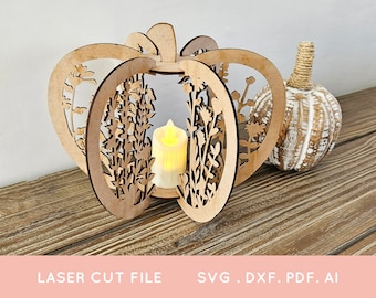 Puede incluir: Una linterna de madera con forma de calabaza cortada con láser, con recortes florales, que contiene una vela que funciona con pilas. A su lado, una calabaza decorativa blanca y marrón con un tallo de cuerda. El texto "LASER CUT FILE" y "SVG . DXF . PDF . AI" está en la parte inferior.