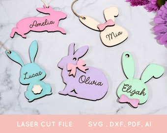 May include: Five laser cut wooden bunny shapes with different colored paint and names written on them. The names are Amelia, Lucas, Mia, Olivia, and Elijah.