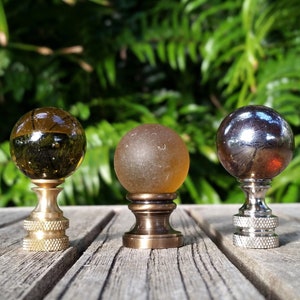 A  one inch amber marble lamp finial available in 3 finishes. Translucent, frosted, and iridescent.