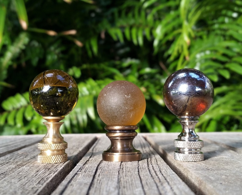 A  one inch amber marble lamp finial available in 3 finishes. Translucent, frosted, and iridescent.