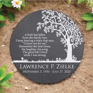 May include: A round black slate memorial stone featuring a white printed tree graphic and the text: A limb has fallen from the family tree. I keep hearing a voice that says, Grieve not for me. Remember the best times, the laughter, the song. The good life I lived while I was strong. LAWRENCE P. ZIELKE NOVEMBER 3, 1956 - JULY 27, 2025.