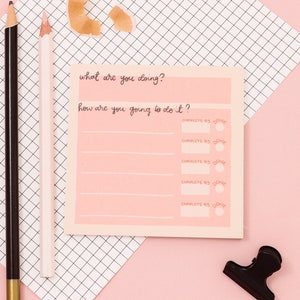 May include: A pink sticky note with the text "what are you doing?" and "how are you going to do it?" with five lines below for writing. Each line has a circle next to it with the text "COMPLETE BY DONE"