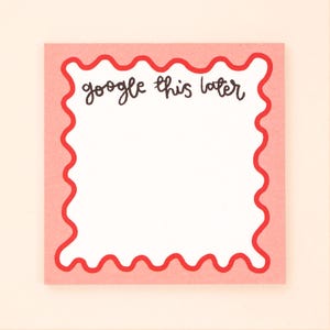 May include: A pink note with a red wavy border. The note says "google this later" in black handwriting.