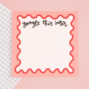 May include: Pink sticky note with a red wavy border. The note says "google this later" in black handwriting.