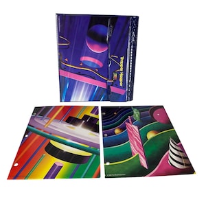 May include: A Trapper Keeper binder with a dark blue cover featuring abstract neon shapes and spheres, accompanied by two matching loose-leaf folders displaying colorful geometric patterns, lines, and spheres in vibrant shades of pink, green, and yellow.