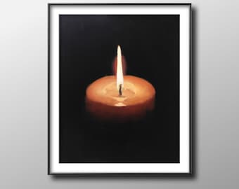 May include: A framed artwork featuring a lit candle against a black background. The candle is a warm orange color, with a bright yellow flame. The artwork is in a black frame, creating a contrast with the candle's glow.
