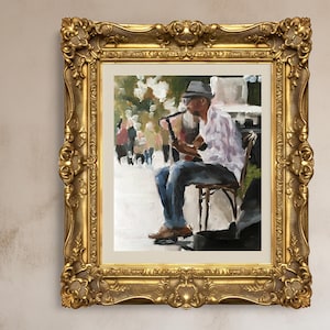 Può includere: Un dipinto a olio in una cornice dorata ornata raffigura un musicista che suona uno strumento a fiato seduto. Il musicista indossa un cappello, occhiali, una camicia di colore chiaro e jeans blu. Lo sfondo mostra una scena di strada sfocata con persone.