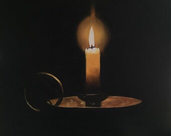 May include: A single candle with a yellow wax body and a small flame is lit in a dark room. The candle is in a brass candlestick with a ring handle.