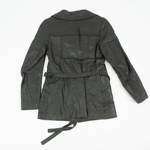 May include: A black leather jacket with a notched collar, long sleeves, and a belted waist. The jacket has a textured appearance and a tie closure at the bottom. The back of the jacket is visible against a white background.