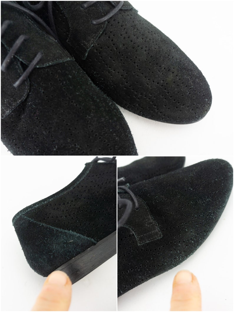 Op de afbeelding: Een paar zwarte su&egrave;de veterschoenen met een geperforeerd ontwerp. De schoenen hebben een ronde neus en een lage hak.