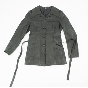 May include: A black leather jacket with a button-up front, long sleeves, and a tie belt. The jacket has a collared neckline and two front pockets. The jacket is displayed on a white background.