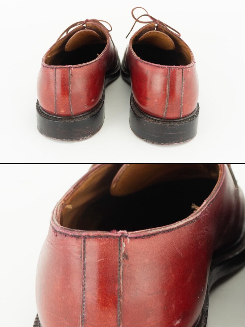 May include: A pair of burgundy leather lace-up shoes with black soles. The shoes are worn and have some scuffs and scratches.