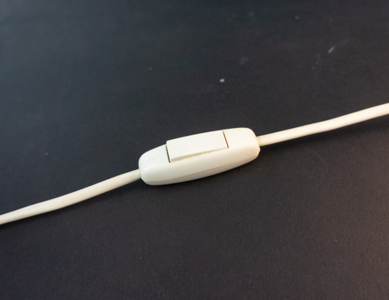 May include: A white inline on/off switch with a white cord attached.